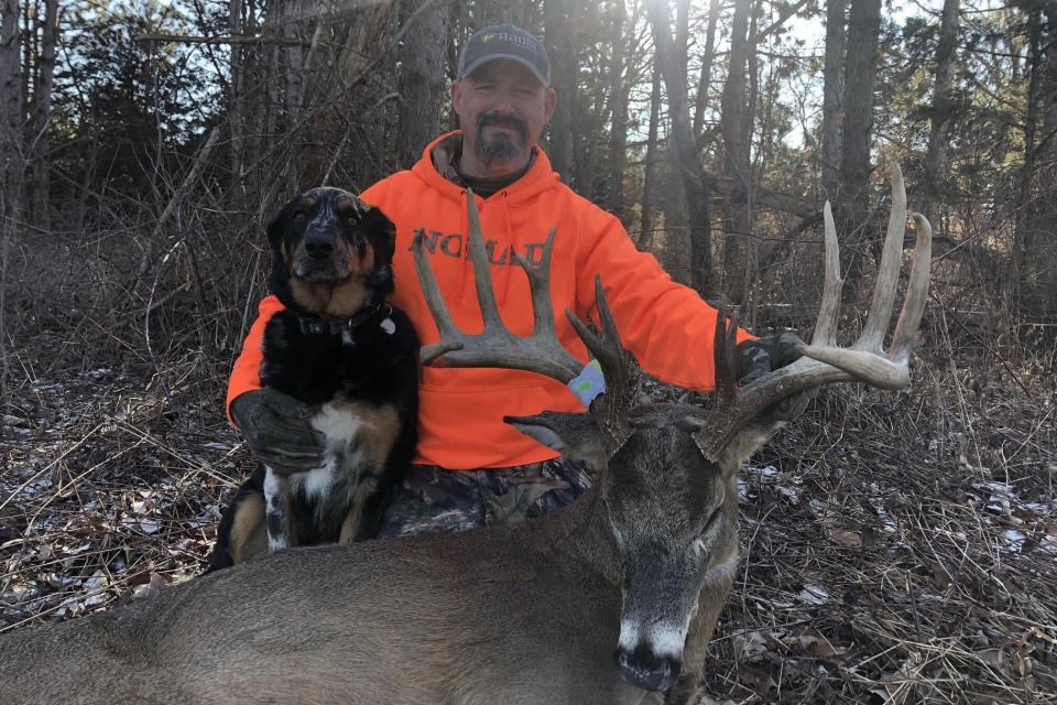 Iowa hunter Scott Rupert poses with a deer he got and his dog.